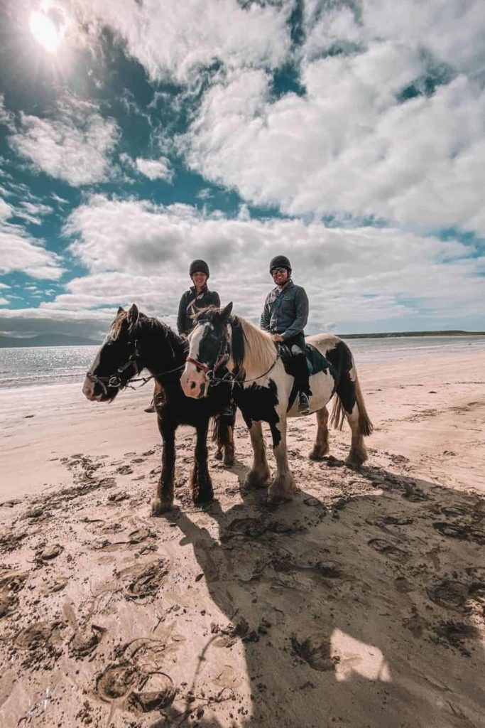 couple horse riding on Ventry beach