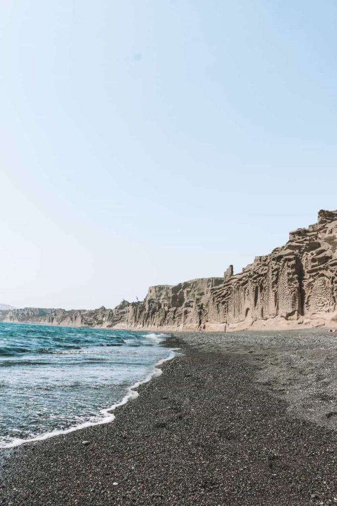 Vlychada beach with black sand and carved cliffs