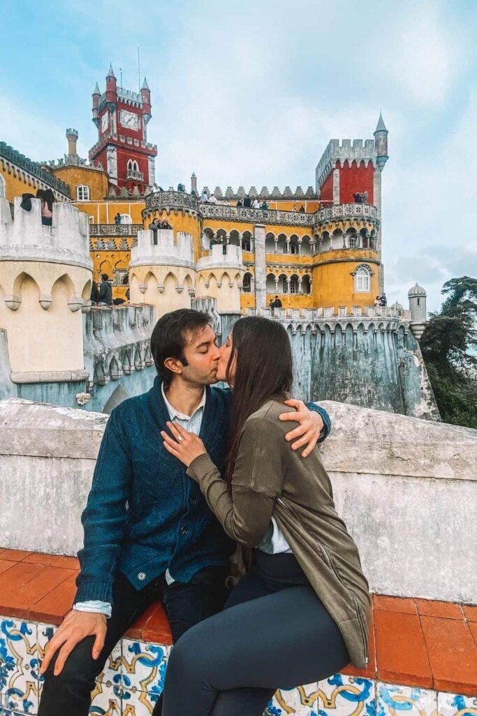 couple in front of Pena Palace in Portugal