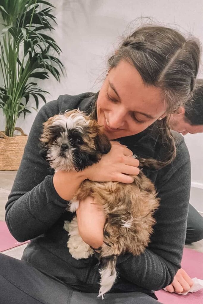 Marie snuggling a Shih Tzu