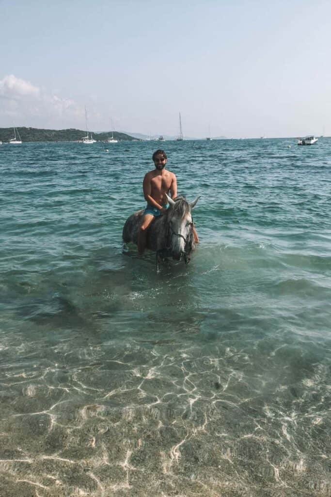 Eric horseback riding in the sea in Corsica