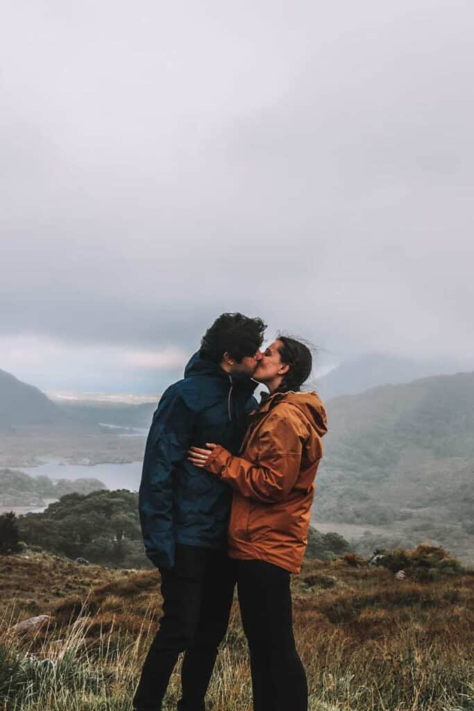 Us kissing in the Ring of Kerry, one of the best road trips for couples in Ireland