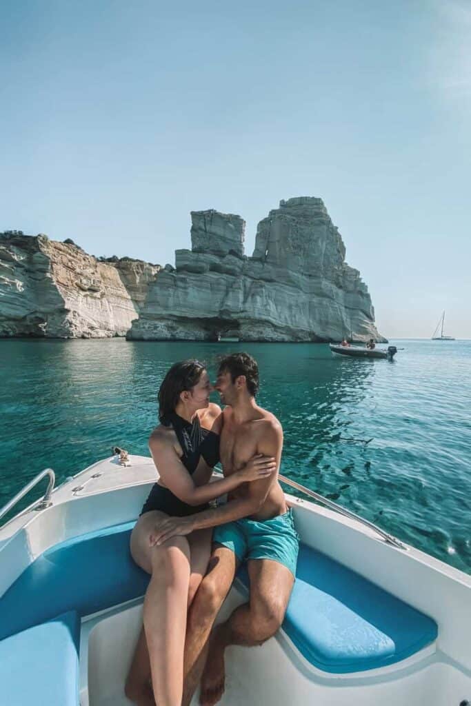 Us on our rental boat in Greece, one of our favorite beach date ideas