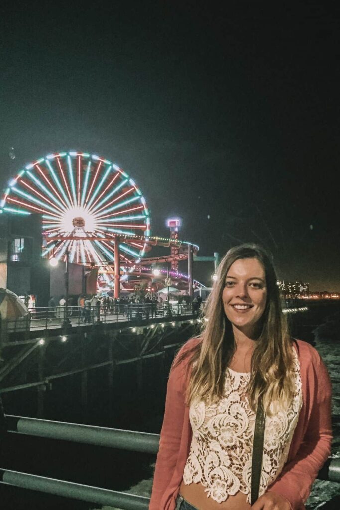Marie by the Santa Monica Pier at night, one of the once in a lifetime things to do in Los Angeles