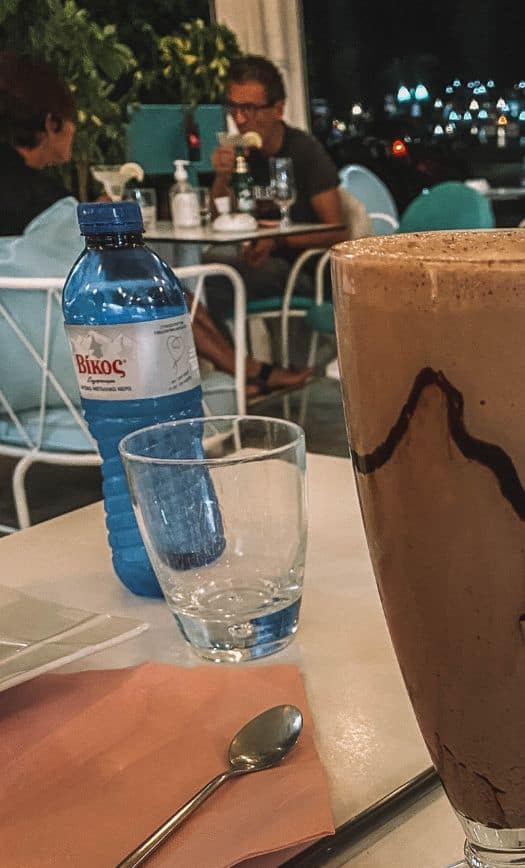 Can you drink tap water in Greece? Our order of a milkshake and a water bottle in Milos