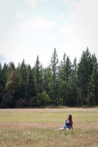 Marie laying in a field in Idaho when she was living there