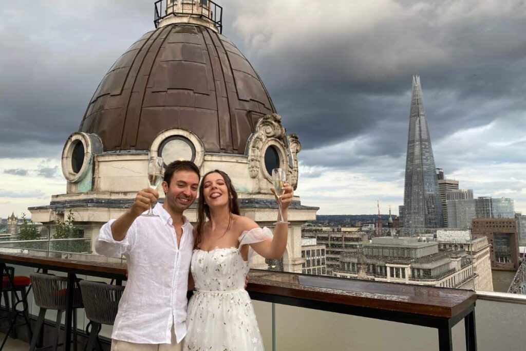 Us raising our glasses at our Wedding Reception with a view over London