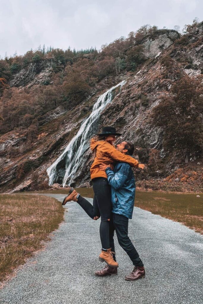 Us kissing while on a Waterfall hiking date in Ireland