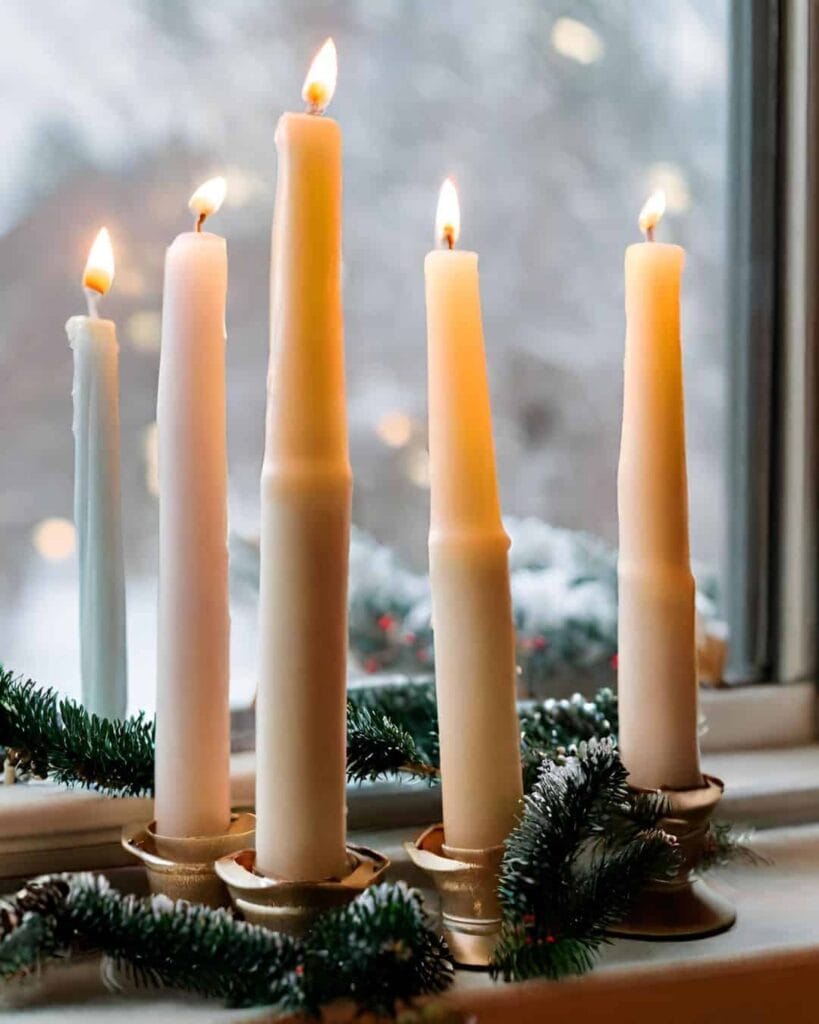 long Christmas candles by the window