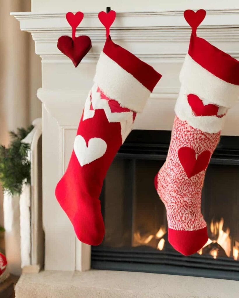 stockings hanging on the fireplace with hearts on them