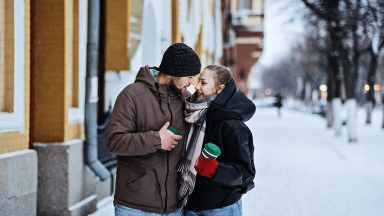couple looking at each other on the snowed street