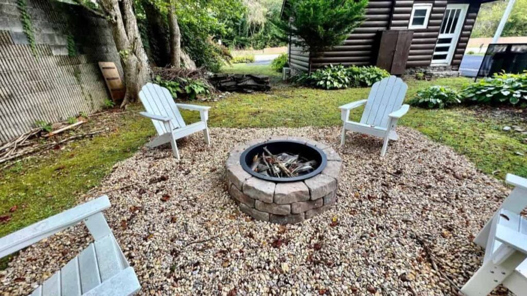 fire pit at cabin with four chairs around it