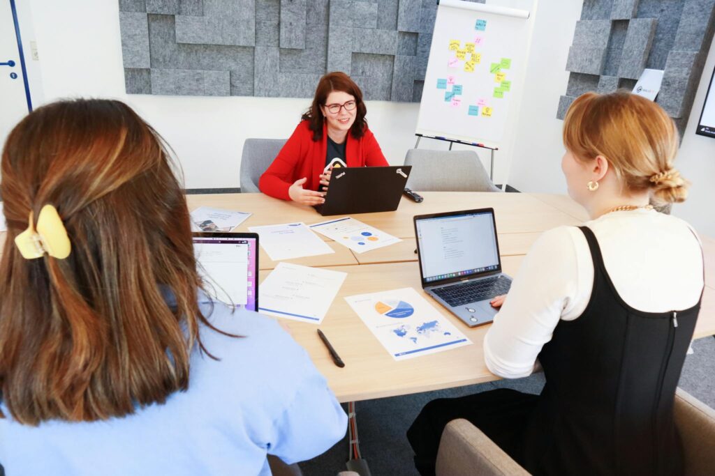 Women having a marketing meeting in a meeting room with a screen