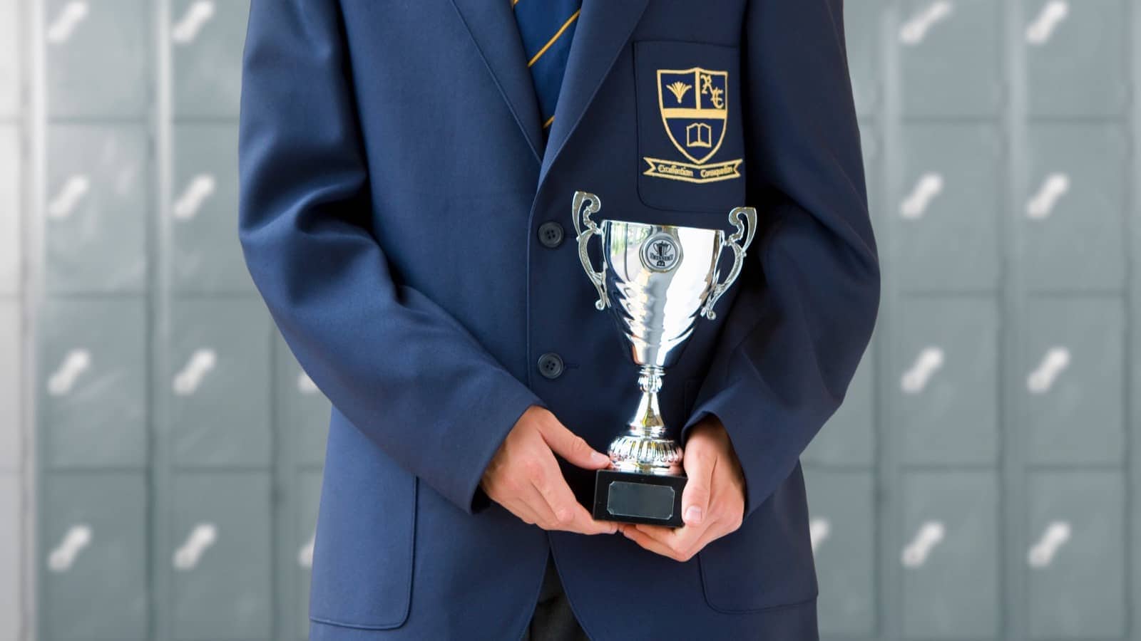 english school uniform winning cup medal shutterstock_1586736412resized