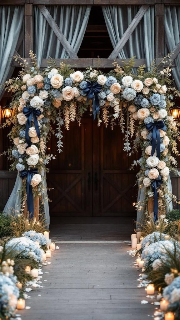 A barn entrance draped with dusty blue and beige fabric, tied with navy ribbons, with pumpkins lining the path.