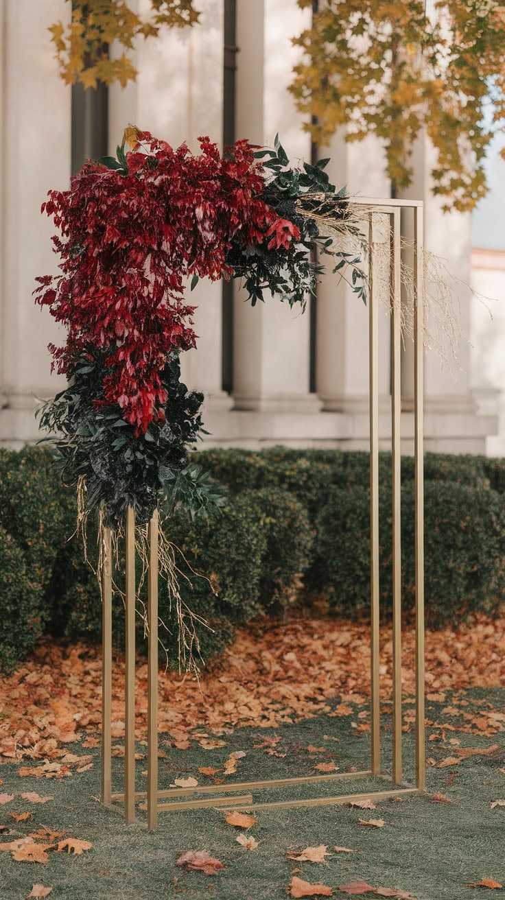 Ceremony backdrop featuring red foliage and a gold frame