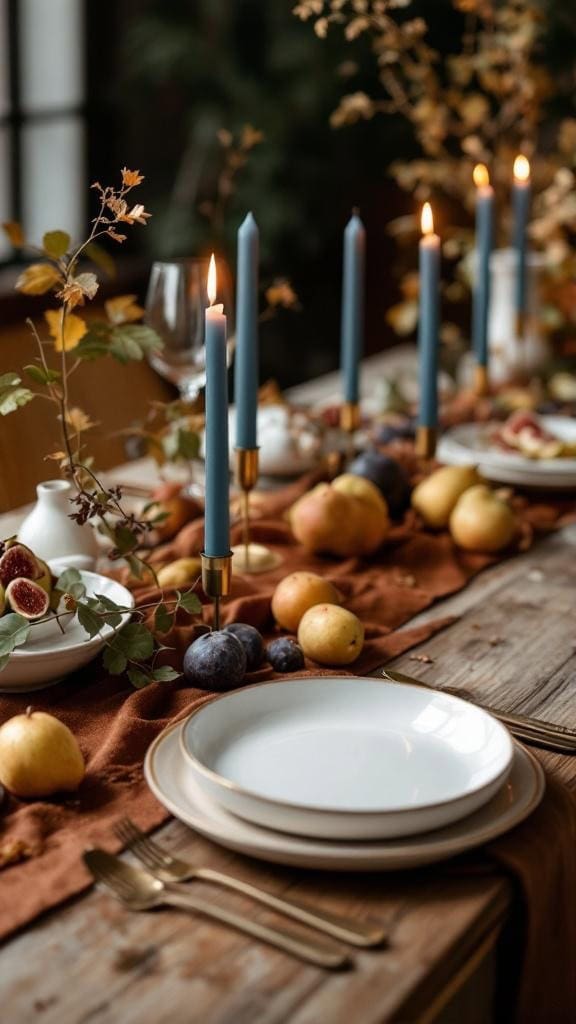 A beautifully decorated table with rust velvet runners, dusty blue taper candles, and scattered fruits.