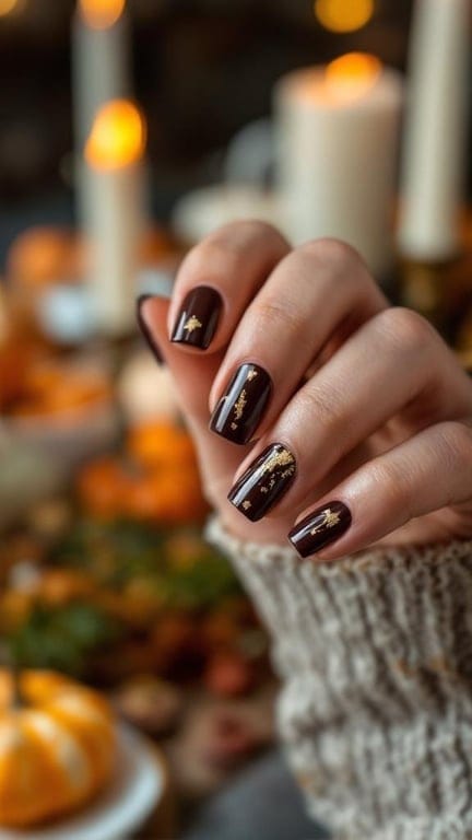 Thanksgiving nails featuring a warm brown base with gold foil accents