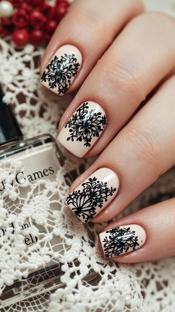 Close-up of nails featuring gothic lace patterns in black on a nude background.