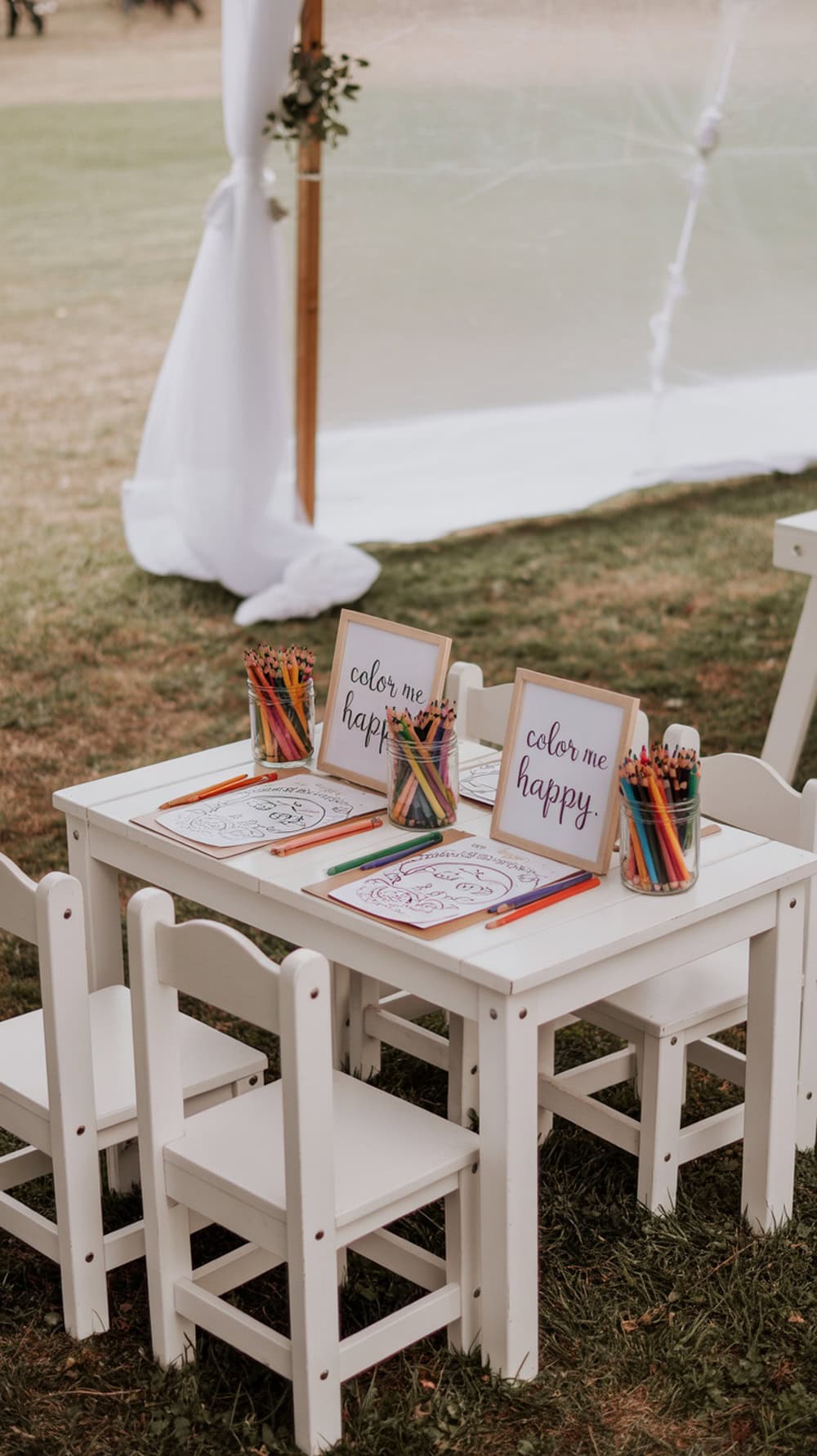 A coloring station for kids at a wedding, featuring a small table with jars of crayons and coloring pages.