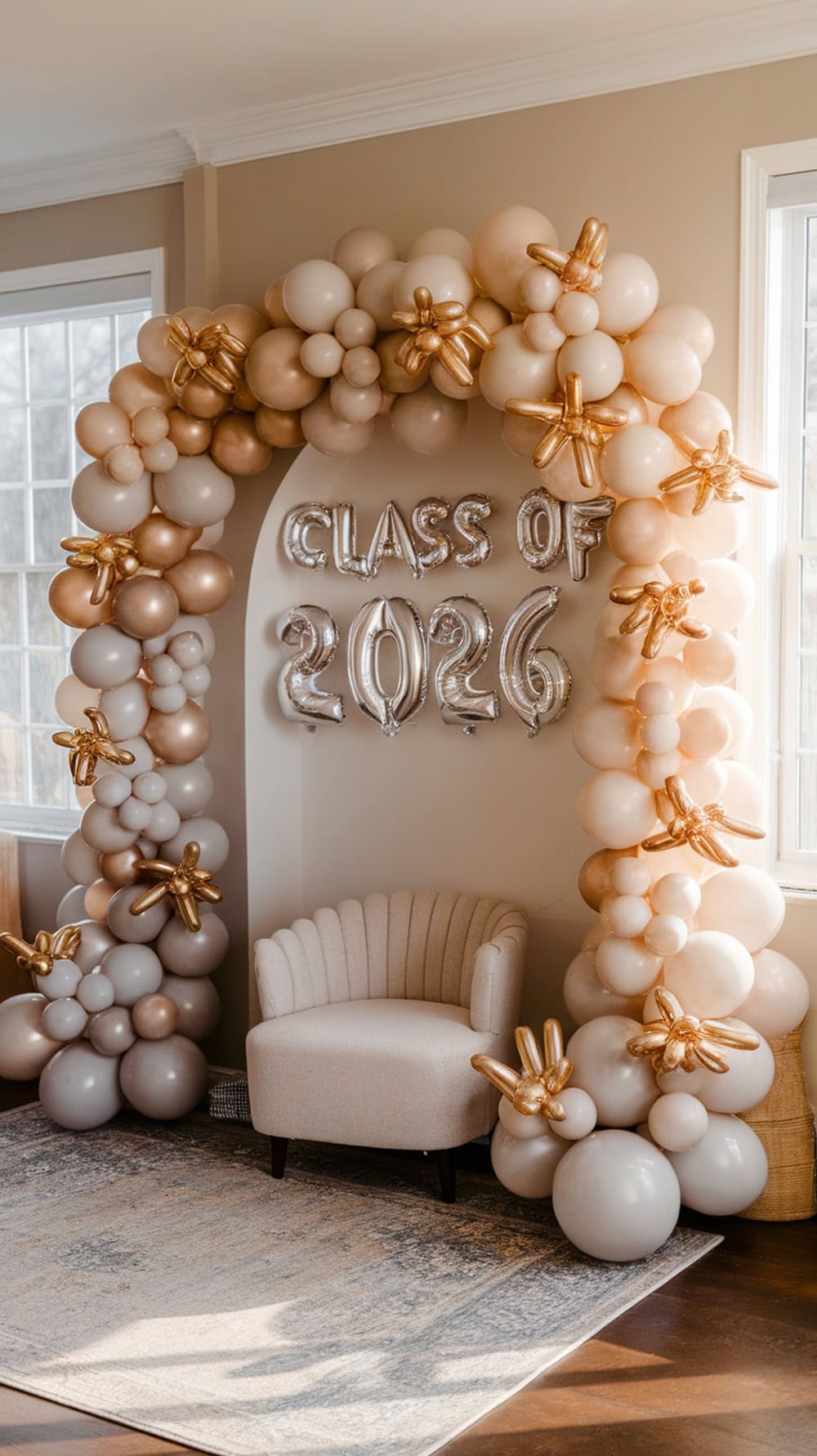 A stylish balloon arch in a living room, featuring pastel colors and the text 'CLASS OF 2026.'
