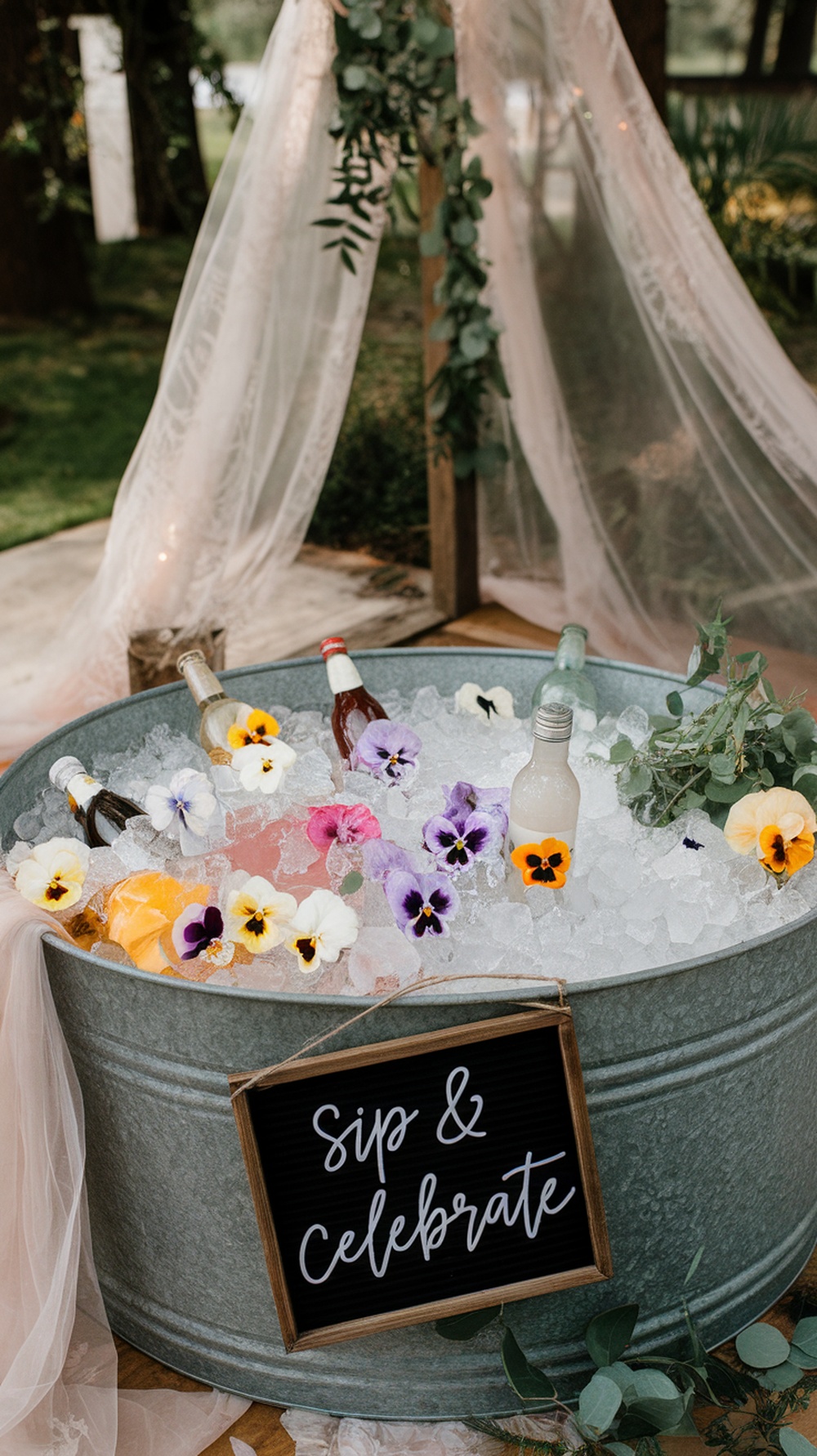 A floral ice bucket drink station with drinks and edible flowers.