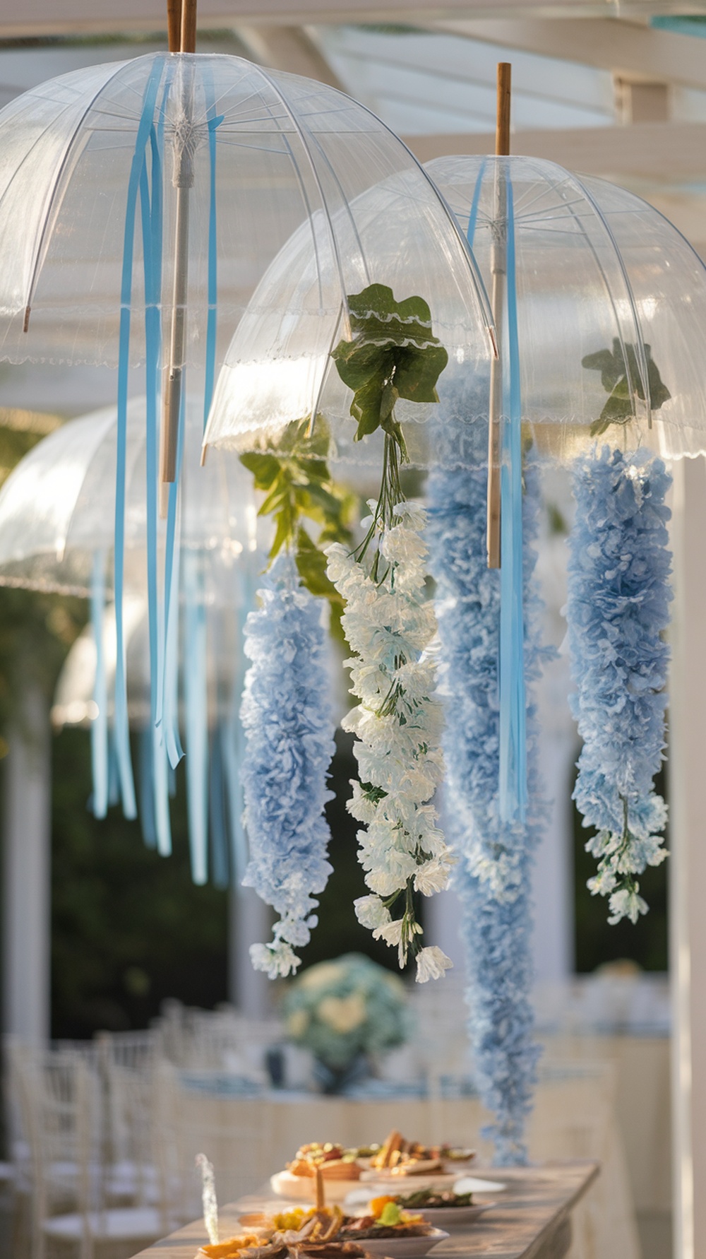 Hanging blue umbrellas decorated with flowers and ribbons for a bridal shower