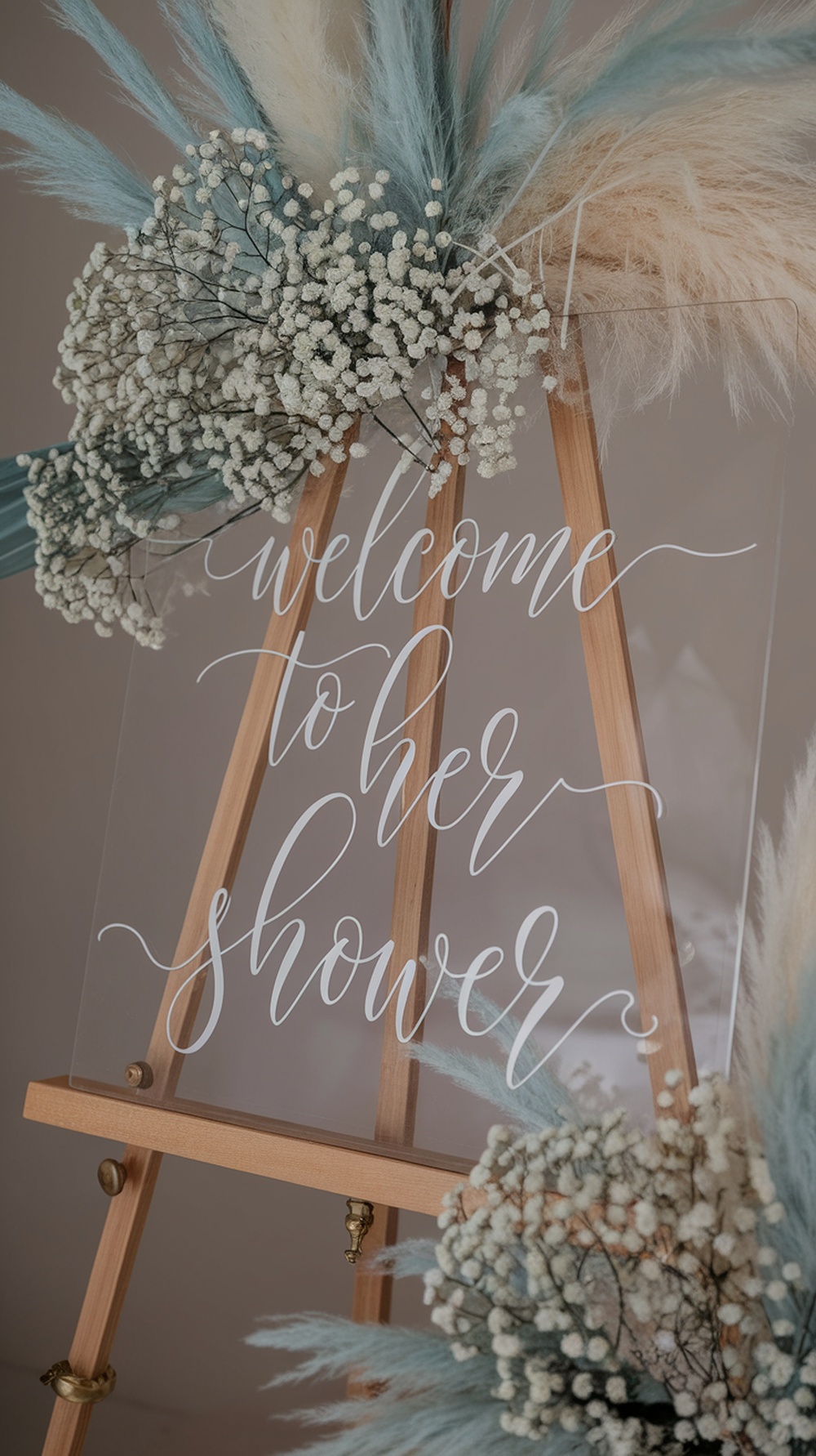 Light blue bridal shower welcome sign with floral decorations