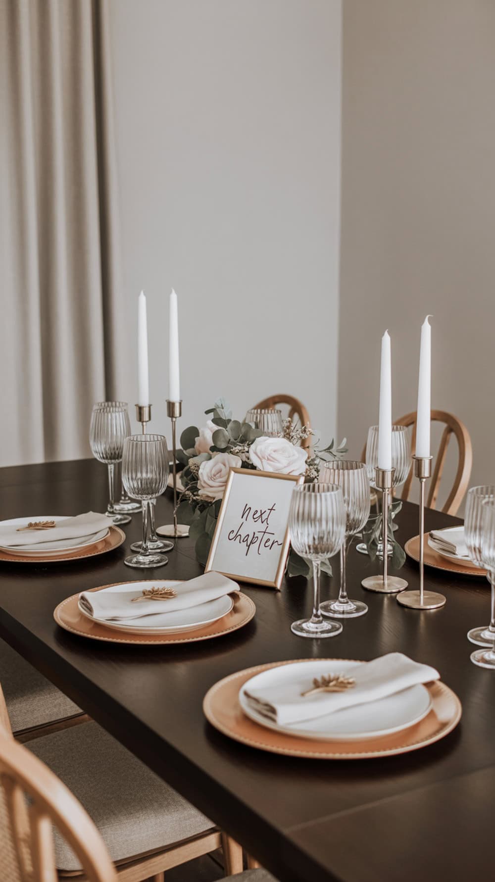 Elegant dining table setup for a graduation party with flowers, candles, and personalized name cards.