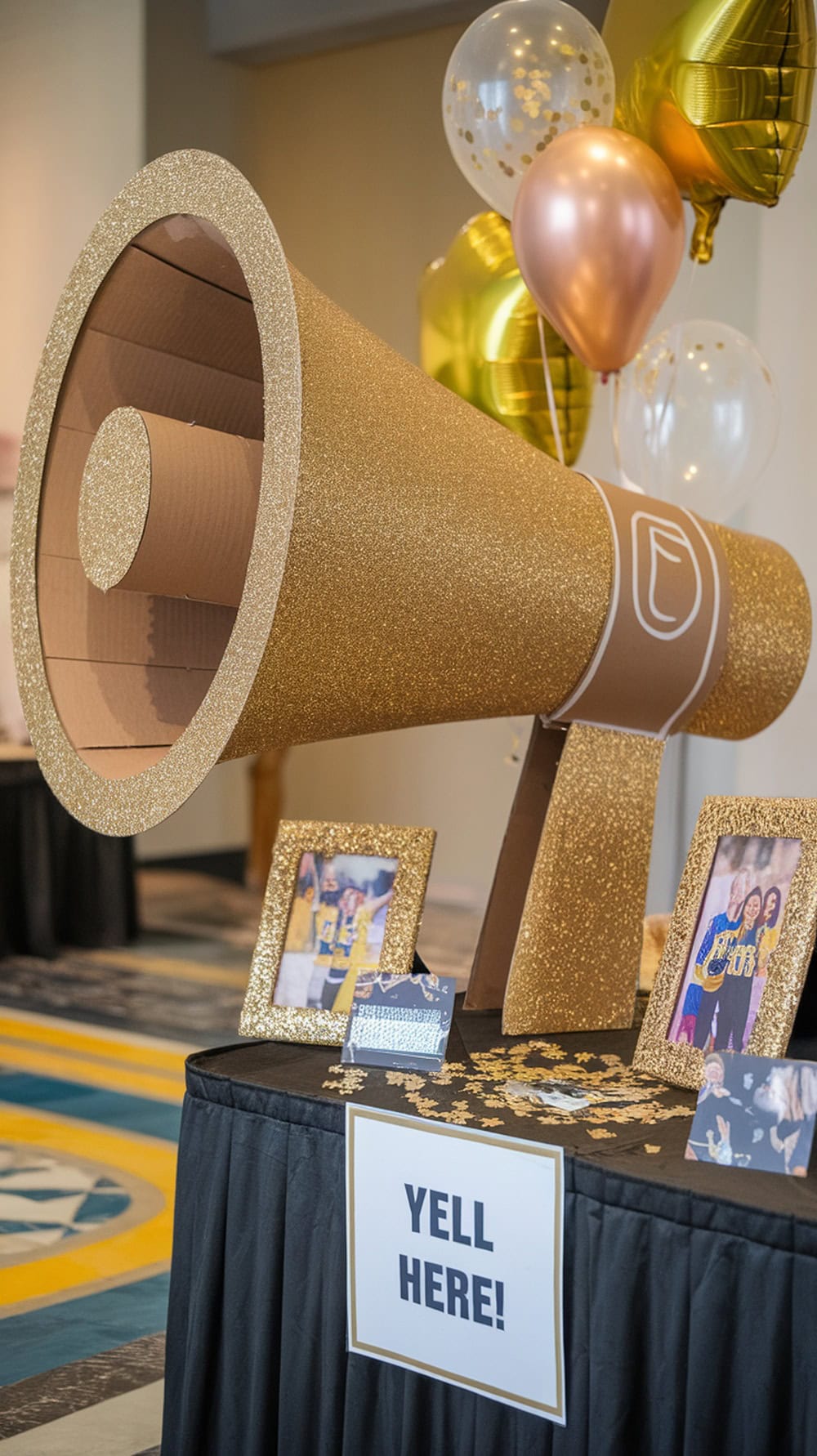 A large glittery cardboard megaphone set up as a gift card drop box at a graduation party.