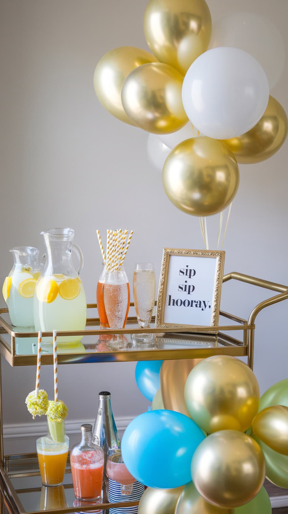 A stylish home bar drink station with colorful drinks, balloons, and a festive sign.