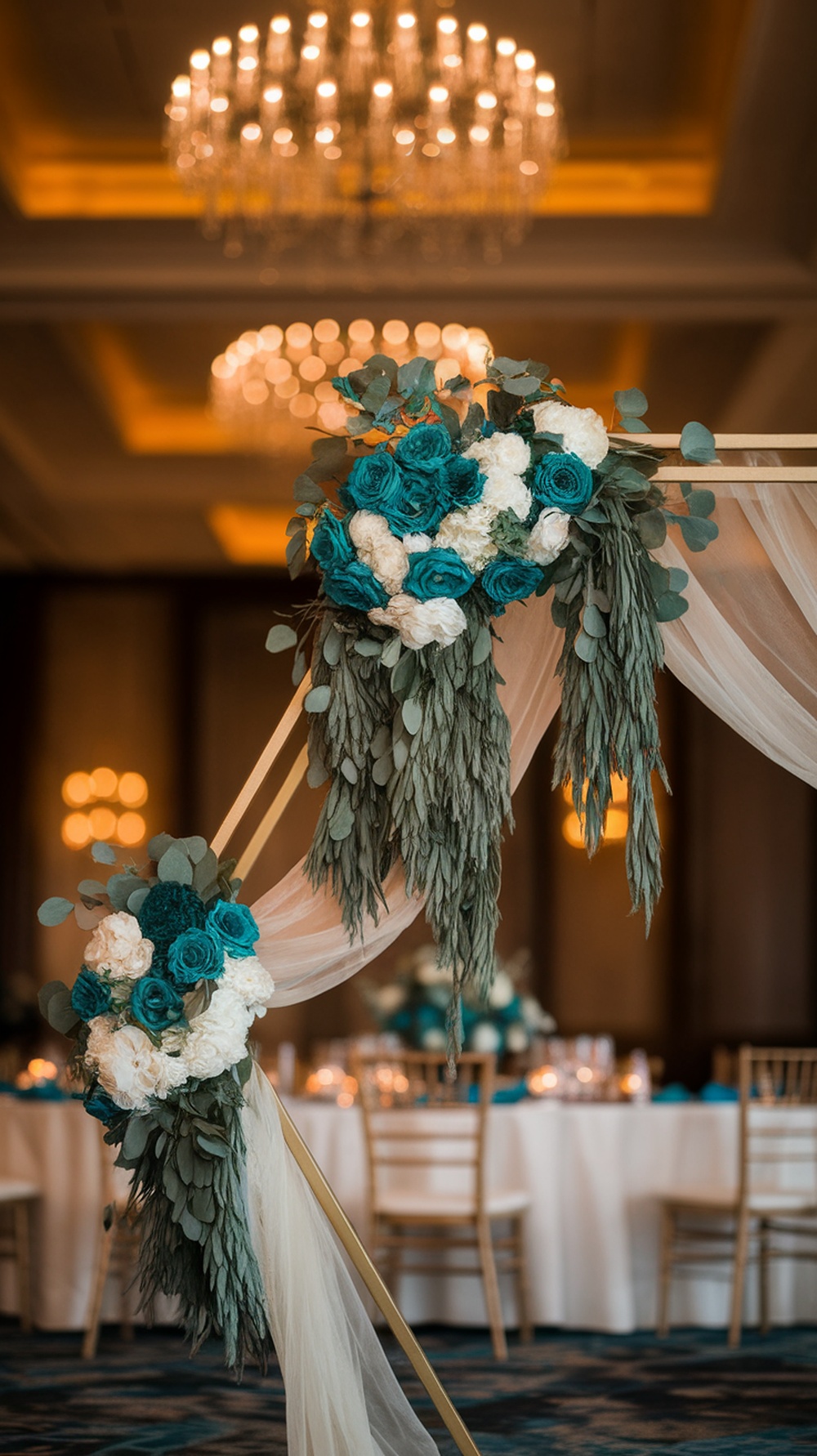 A beautiful teal wedding arch adorned with flowers and greenery, set in an elegant venue.