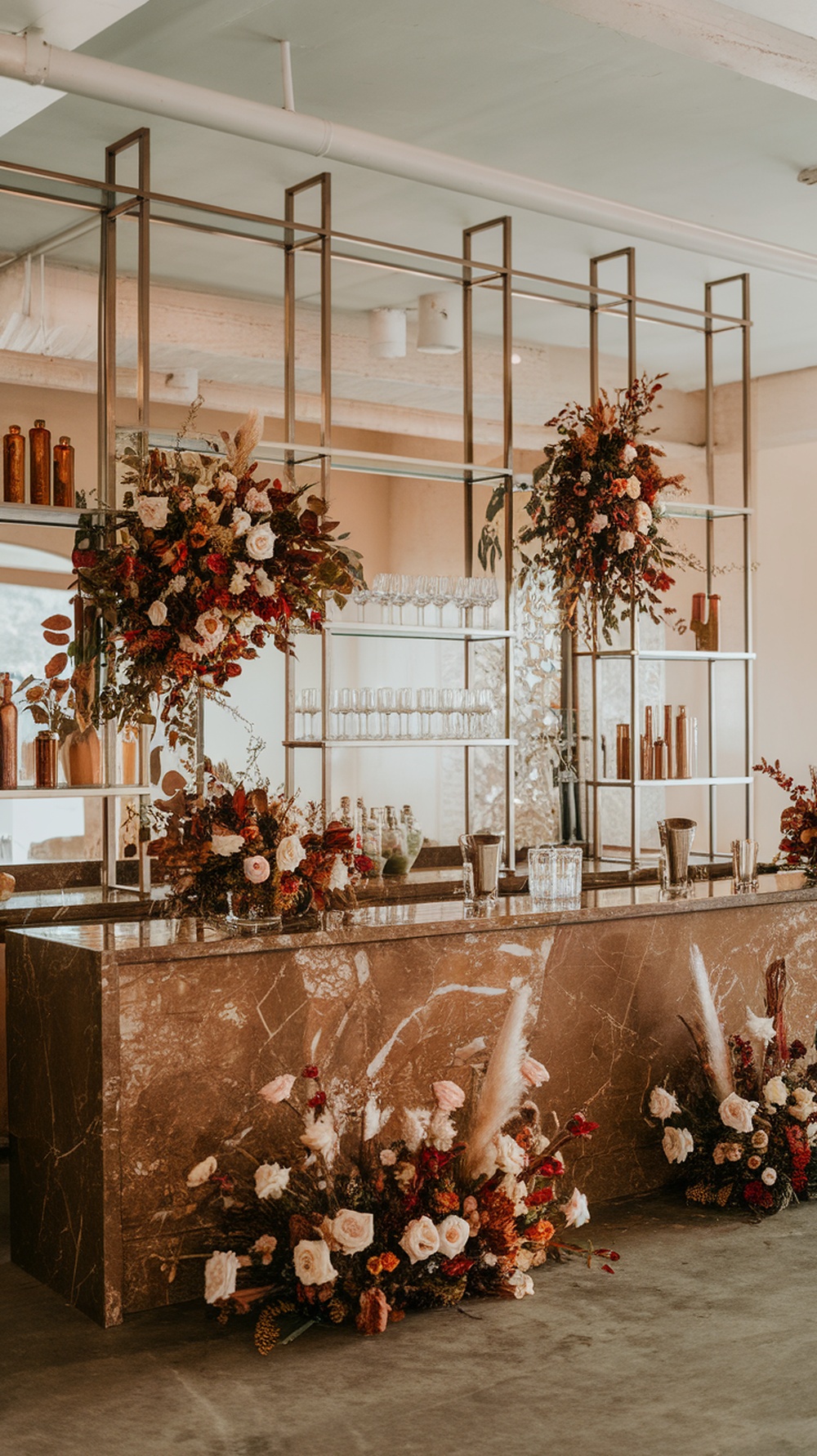 Elegant brown marble wedding bar setup with floral arrangements